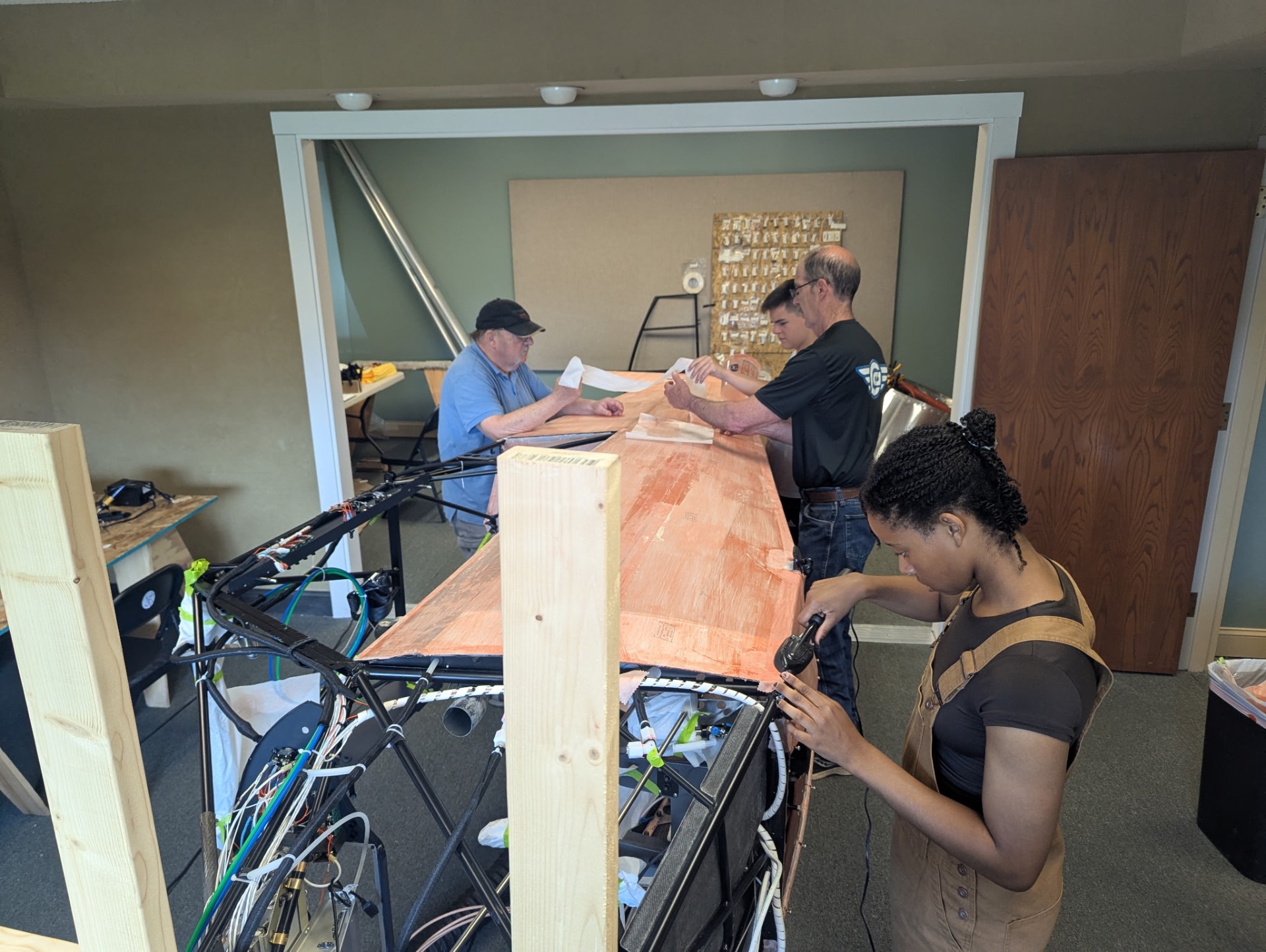 Volunteers and students working on the Carbon Cub aircraft build