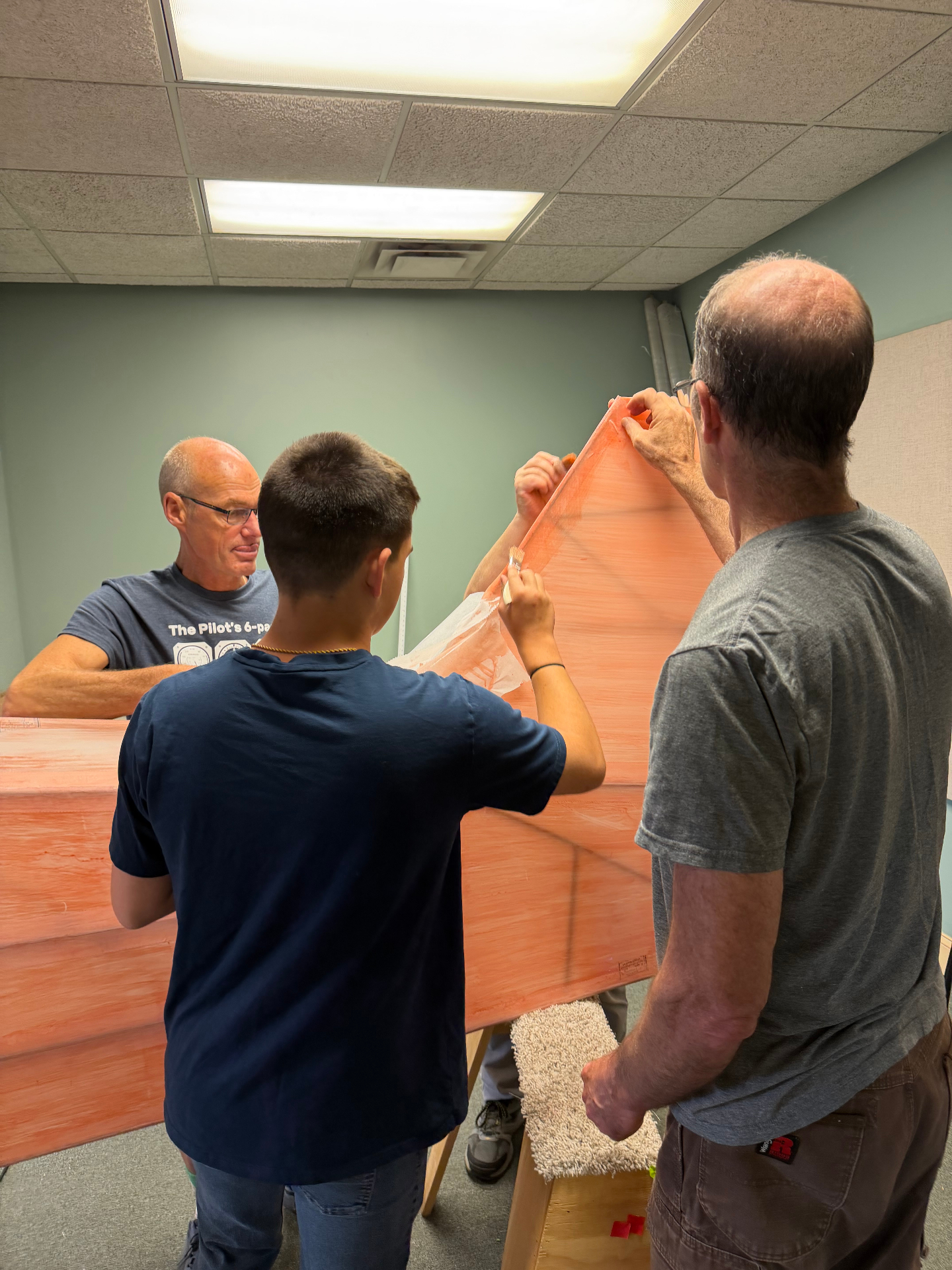 Volunteers and students working on the Carbon Cub aircraft build